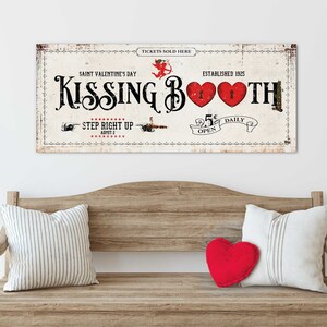 A playful 48x20'' 'Kissing Booth' canvas sign, with vintage typography and heart motifs, evoking a nostalgic Valentine's Day theme