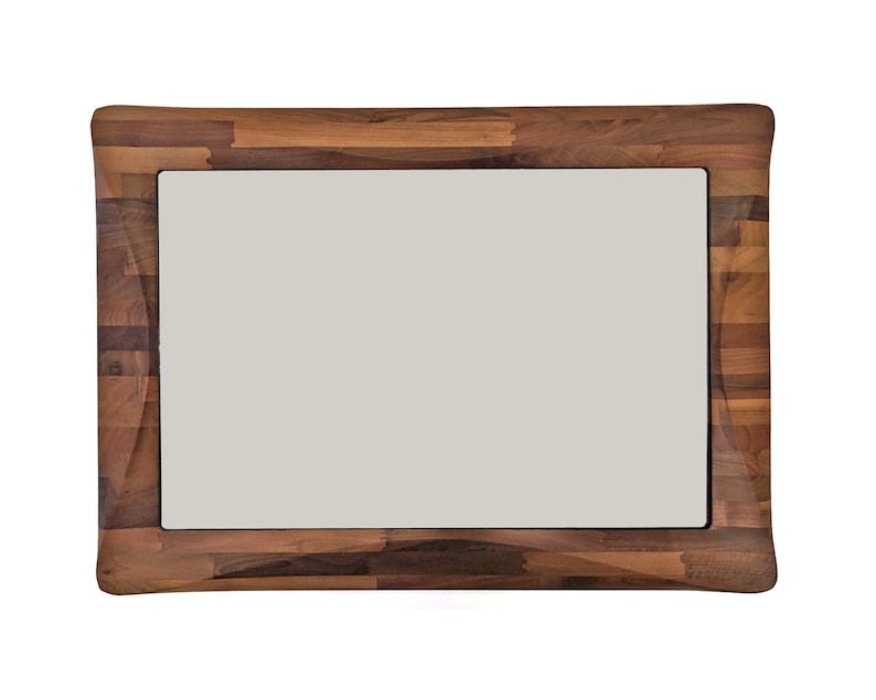 May include: A large rectangular mirror with a thick, dark brown wooden frame made of multiple pieces of wood.