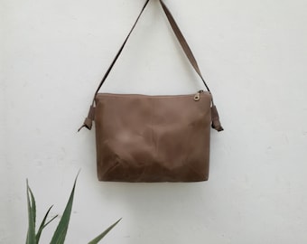 Minimal crossbody bag with hand waxed fabric, a travel purse with leather straps, a waterproof zipper handbag