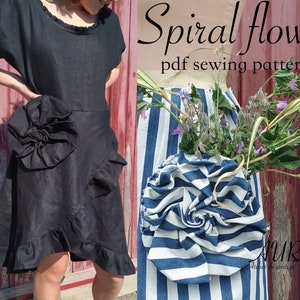 May include: A black linen dress with a large, ruffled flower detail on the side. The dress has a scoop neck and short sleeves. The dress is shown on a model against a red wooden background. The text "Spiral flower pdf sewing pattern" is displayed above the model.