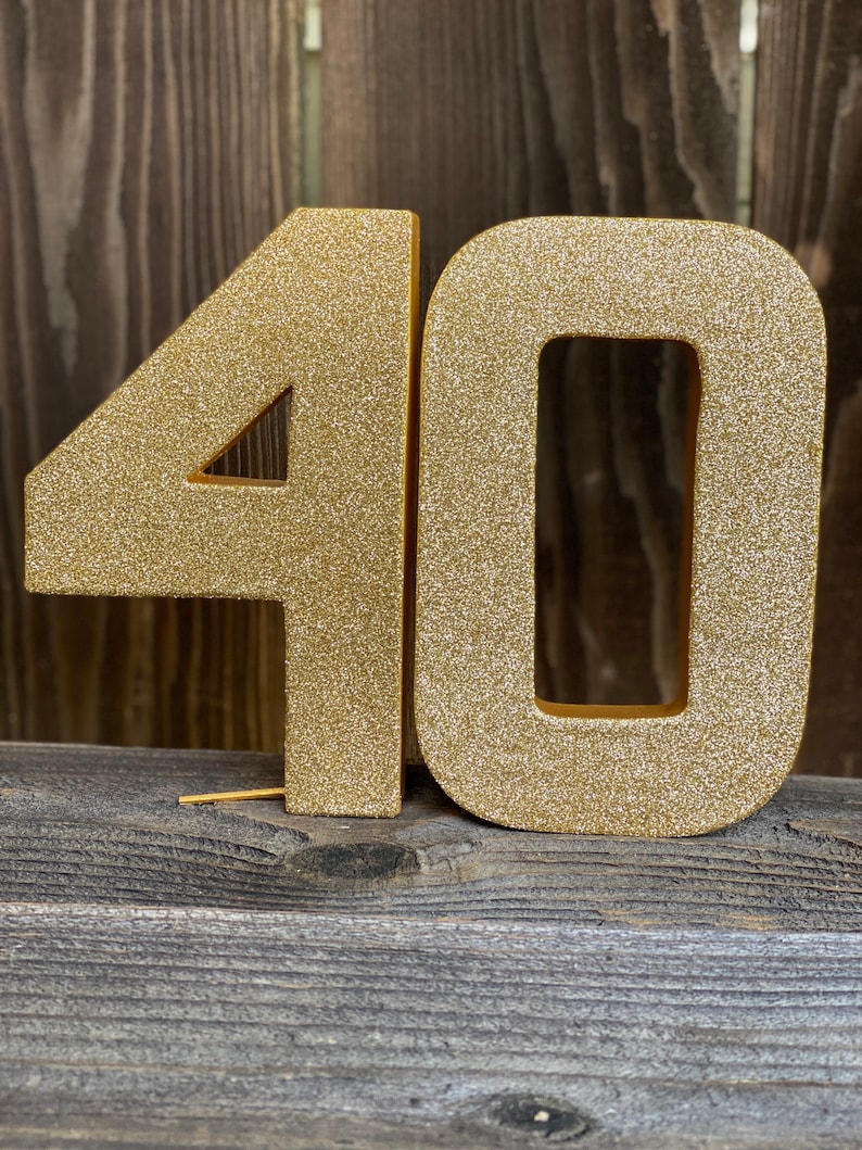 May include: Gold glitter number 40, a popular choice for birthday decorations.