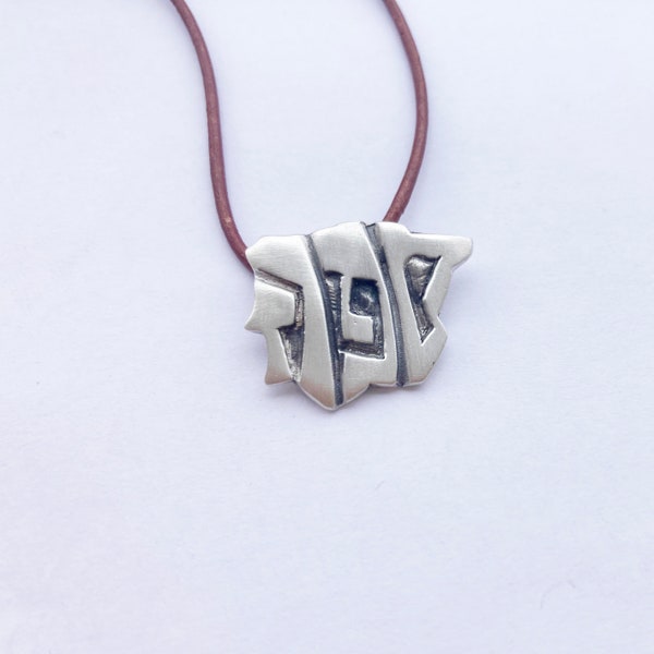 Sepharad map. Pendant in the shape of the Iberian Peninsula, with the word Sepharad written on it in Hebrew.