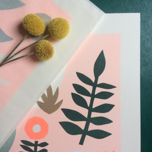 Puede incluir: Una impresi&oacute;n rosa y blanca con un dise&ntilde;o de hojas verdes, formas de hojas marrones y una flor rosa con un centro blanco. La impresi&oacute;n est&aacute; sobre un fondo blanco.