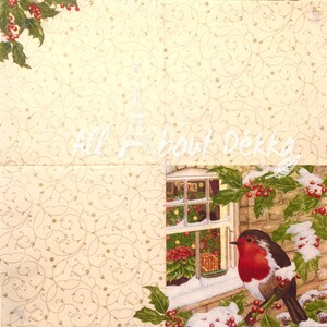 May include: A red robin bird perches on a branch outside a window with a Christmas tree visible inside. The window is framed by brick and snow. Holly berries and green leaves are visible in the foreground.