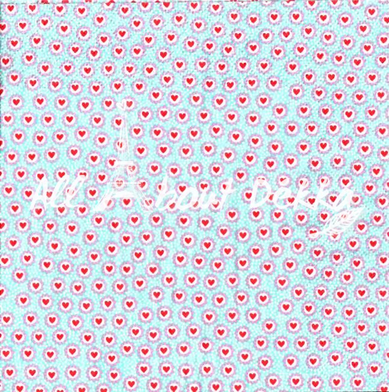 May include: A light blue background is covered with a pattern of red hearts and pink floral accents. The words "All about Dekka" are written in white script, with a white Eiffel Tower graphic.
