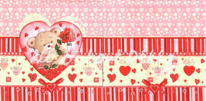 May include: A decorative paper napkin with a Valentine's Day theme. The design features a teddy bear holding a red rose inside a heart, surrounded by hearts and ribbons in shades of pink and red.