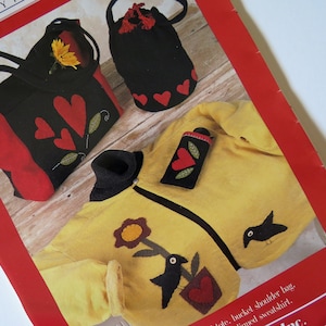 May include: A craft book featuring a yellow sweater with a black bird and flower applique, a black bag with red hearts, and a red and black tote bag with hearts.