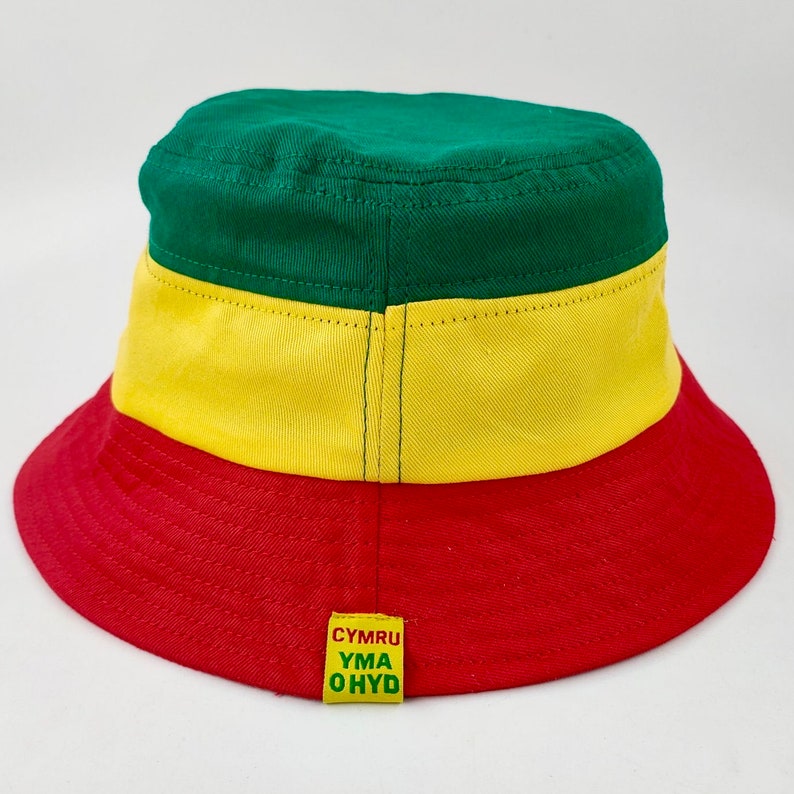 May include: A green, yellow, and red bucket hat with the text "CYMRU YMA OHYD" on the back.