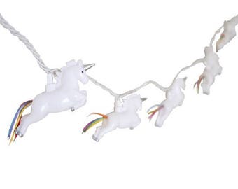 May include: A string of white unicorn fairy lights with rainbow tails. The lights are strung together with a white wire.