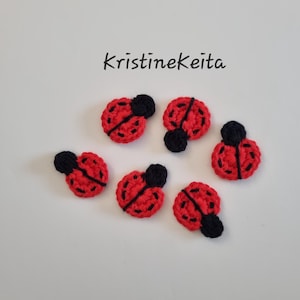 May include: Six small, circular, crocheted ladybug appliques in bright red with black yarn details for the head and wing divisions. Each piece features a textured, handmade stitch pattern. The text KristineKeita is printed above the items.