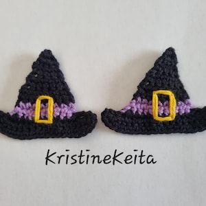 May include: Two black crocheted witch hats with a purple band and a yellow rectangular buckle. The hats are identical in design and color. The text KristineKeita is printed in black below the two hats on a plain white background.