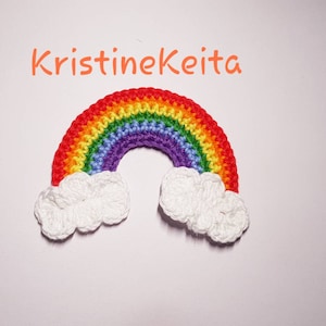 May include: A crocheted rainbow with red, orange, yellow, green, blue, indigo, and violet stripes. The rainbow is topped with two white crocheted clouds.