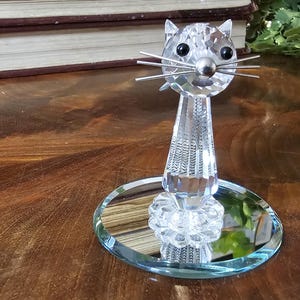 Swarovski Vintage Crystal Cat with silver whiskers and tail. Sits gracefully atop bevel edge mirror. Very good condition. Ships FREE in USA