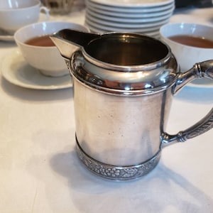 Antique Silver Milk Jug exudes quality in design of leaves, flowers, weight. In Great Condition. Polished, ready to use. Ships FREE in USA