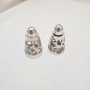 Pair of vintage Sterling Silver Salt and Pepper Shakers. Handmade with glass inserts. Great condition. Ready to use. Ships FREE in USA