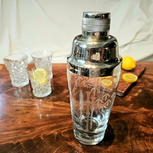 Bamboo Etched Coctail Shaker with 2 peice top. Nice thick glass in great condition. Ready to use. Ships FREE in USA