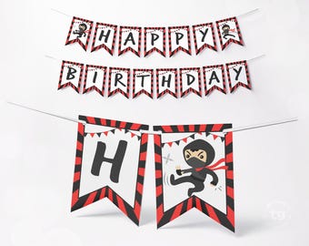 May include: A decorative party banner set featuring the text HAPPY BIRTHDAY on individual pennants. Each pennant has a white center with black and red striped borders. The design includes cartoon ninja illustrations and small red bunting accents.