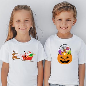 May include: Two children wearing white t-shirts with holiday-themed designs. The girl's shirt features a cartoon Santa Claus riding in a sleigh pulled by a reindeer. The boy's shirt features a cartoon pumpkin filled with candy and a spider web.