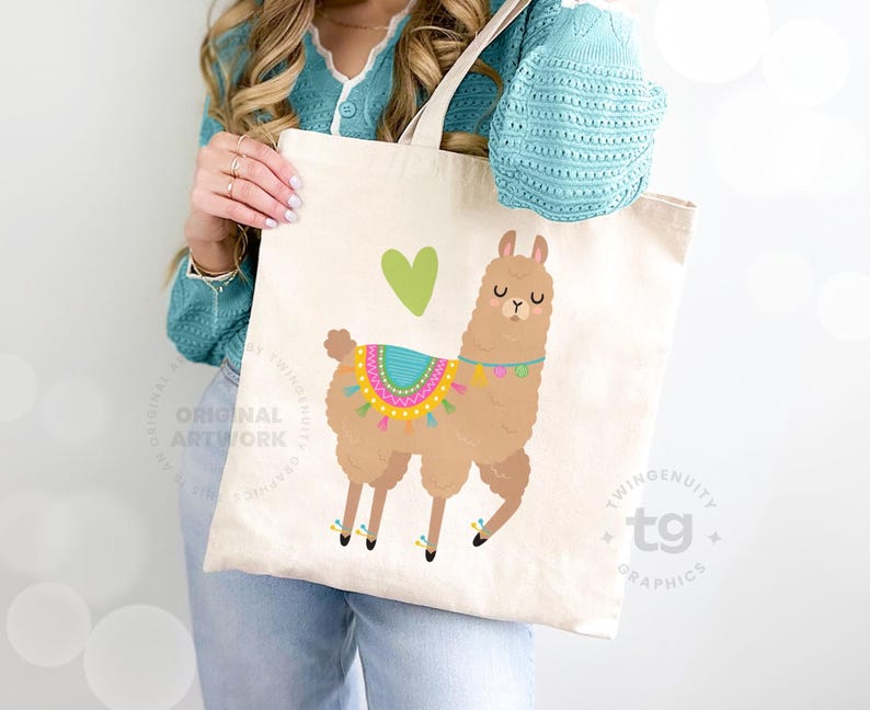 A closeup of a woman holding a tote bag leaning against the wall. The tote bag is front and center and features one of the llamas with a little green heart on the front.