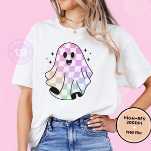 The rainbow ghost is on a white t-shirt mockup against a light pink background.