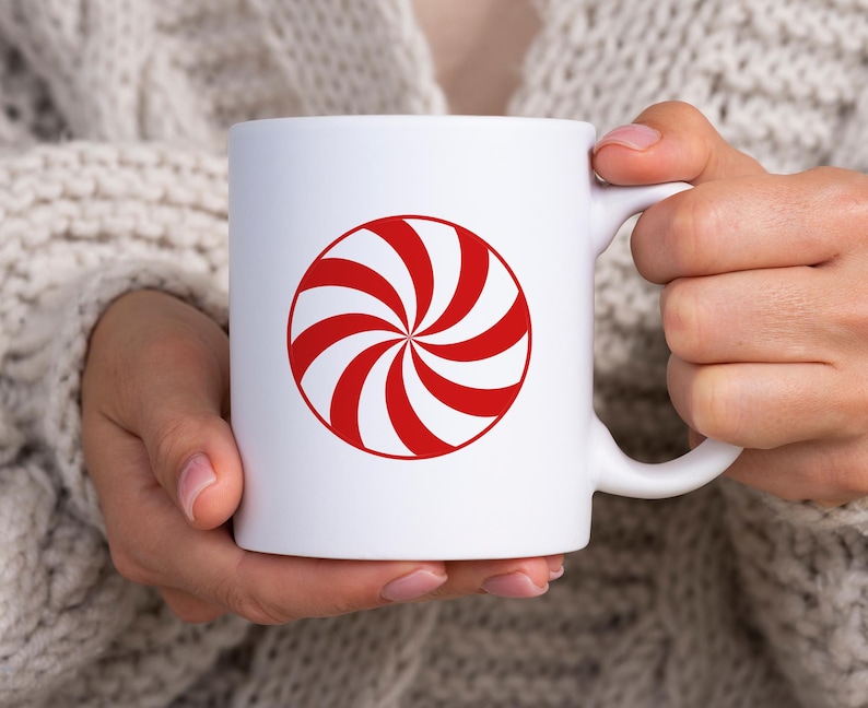 Puede incluir: Taza de cer&aacute;mica blanca con un dise&ntilde;o de caramelo de menta rojo y blanco.
