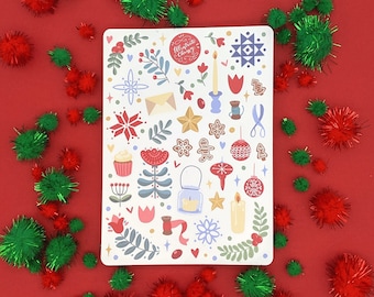 May include: A white card with a festive Christmas design featuring a variety of illustrations including a gingerbread man, a candle, a star, a bell, a Christmas tree, and a wreath. The card has the text "Celebrate Christmas" in a red circle.