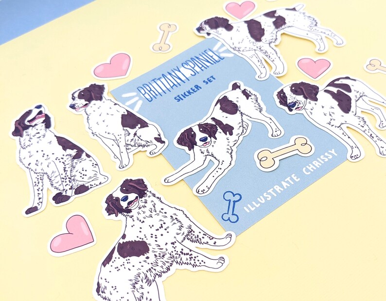 May include: A set of stickers featuring illustrations of Brittany Spaniel dogs in various poses. The stickers are on a light blue background with the text "Brittany Spaniel Sticker Set" and "Illustrate Chrissy". The stickers include hearts and bones.