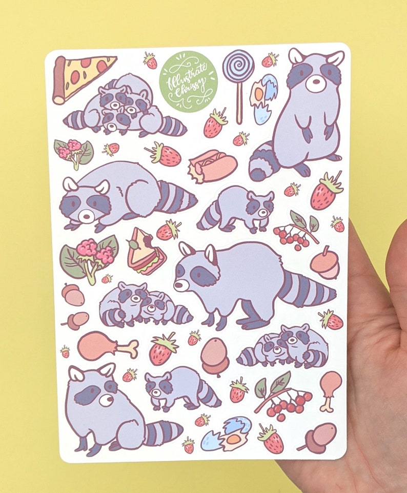 May include: A sticker sheet featuring cartoon raccoons, strawberries, pizza, and other food items. The raccoons are in various poses, with a light purple and gray color scheme. The text "Illustrate Chrissy" is also present.