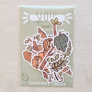 May include: A set of sloth stickers in a clear plastic bag. The stickers feature sloths hanging from branches, leaves, and the text "Sloth Sticker" and "Illustrate Chrissy".