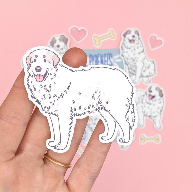 May include: A white Great Pyrenees dog sticker with a pink background. The sticker is part of a set of dog stickers with bone and heart designs.