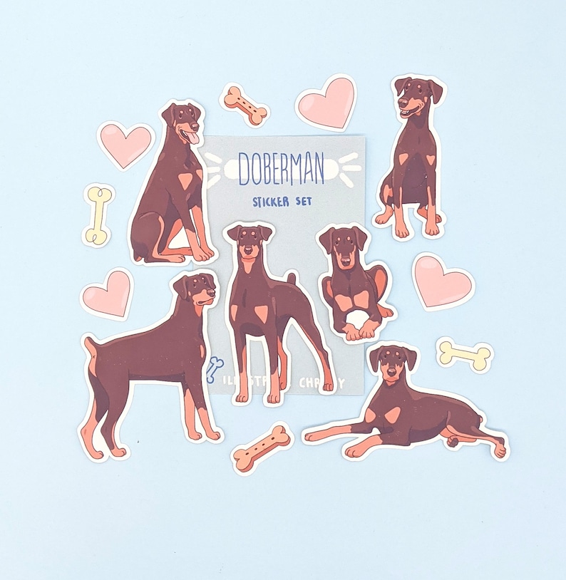 May include: A set of Doberman Pinscher dog stickers. The stickers are in various poses and feature a brown and black color scheme. The sticker set includes hearts, bones, and the text "Doberman Sticker Set".