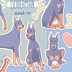 May include: A sticker set featuring illustrations of Doberman Pinschers in various poses. The stickers are on a light blue background with the text "Doberman Sticker Set" and a bone graphic.