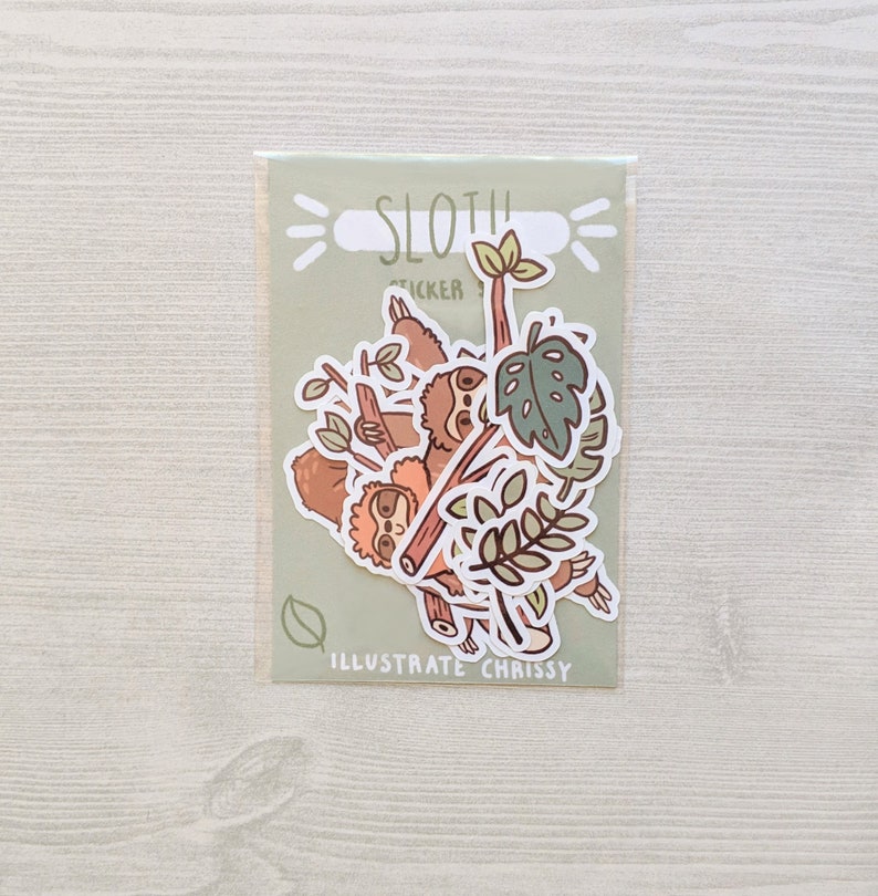 May include: A set of sloth stickers featuring multiple sloths hanging from branches with green leaves. The stickers are on a light green background with the text "Sloth Sticker" and "Illustrate Chrissy".