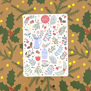 May include: A white sticker sheet with a festive Christmas design. The sticker sheet features a variety of illustrations including red berries, green leaves, blue vases, and a red tulip. The text "Celebrate Christmas" is written in red cursive on a red circle.