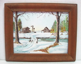 May include: A framed painting of a winter scene with two houses, a windmill, and a snow-covered path. The painting is signed "Francis Briman '76".
