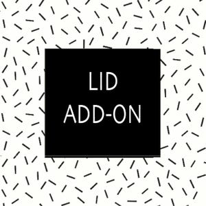 May include: A black square with the words "LID ADD-ON" in white text. The background is white with a pattern of black dashes scattered across the surface.