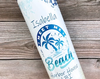 May include: White stainless steel tumbler with a blue watercolor design and the text "Meet Me At The Beach Harbor House LBI" and the name "Isabella" at the top.