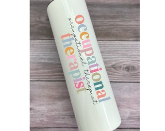 May include: White stainless steel tumbler with a colorful design that says "occupational therapist".