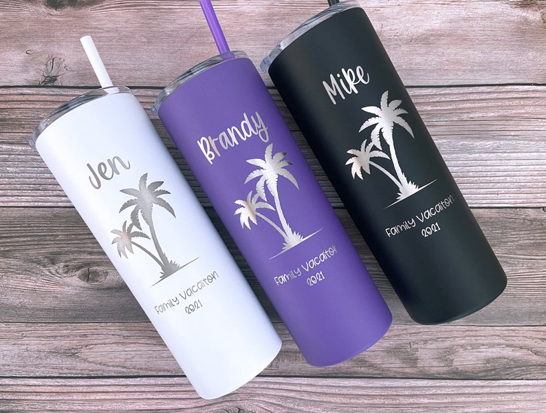 May include: Three stainless steel tumblers with personalized names "Jen", "Brandy", and "Mike" and palm tree graphics. Each tumbler has the text "Family Vacation 2021" engraved on the bottom.