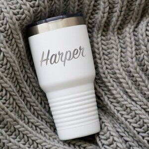 May include: White stainless steel tumbler with a silver lid and the name "Harper" engraved on the side.