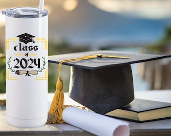 May include: White stainless steel tumbler with a black graduation cap, gold scroll, and green leaves. The text "class of 2024" is printed on the tumbler.