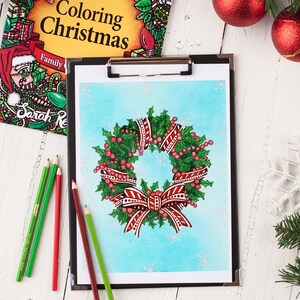 May include: A Christmas wreath with red and white striped ribbon and red berries on a blue background with snowflakes.