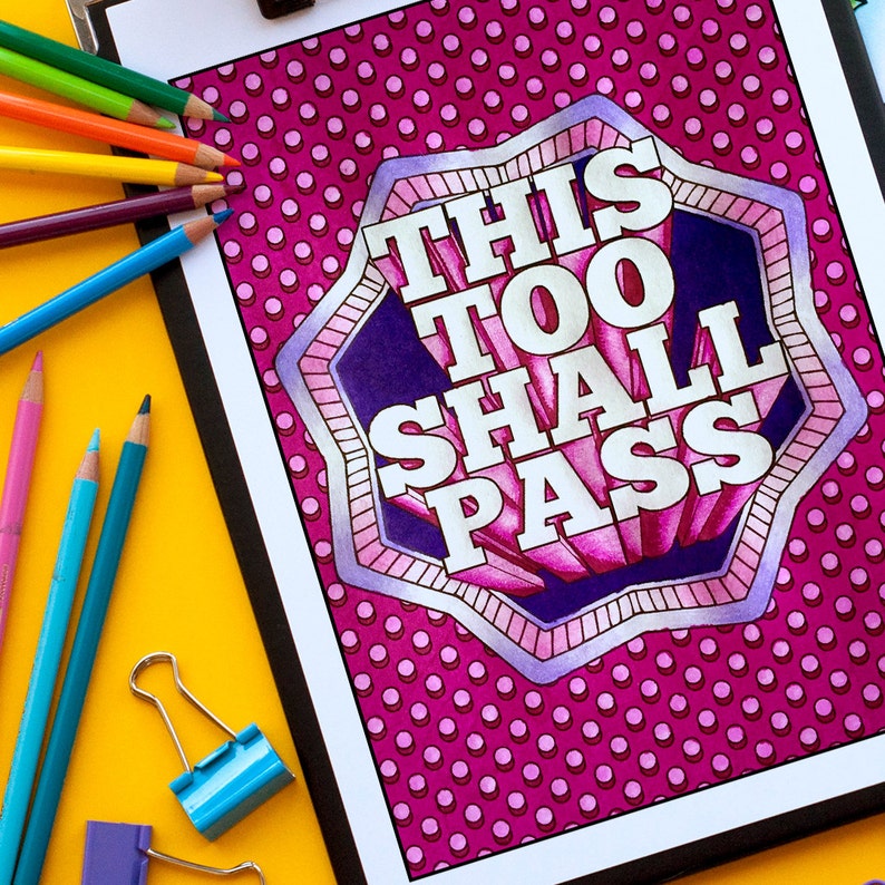 May include: A pink and purple printable colouring page with a white outline of a starburst shape. The text "This Too Shall Pass" is written in white letters inside the starburst.