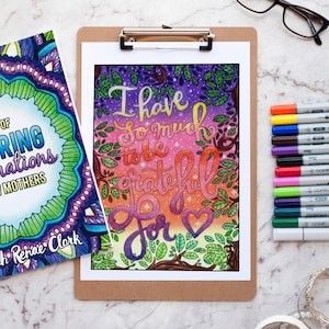 May include: A printable colouring page with a colourful background and the text "I have so much to be grateful for" with a heart at the end. The text is in a stylised font and the background is a gradient of pink, purple, and blue with stars and leaves.