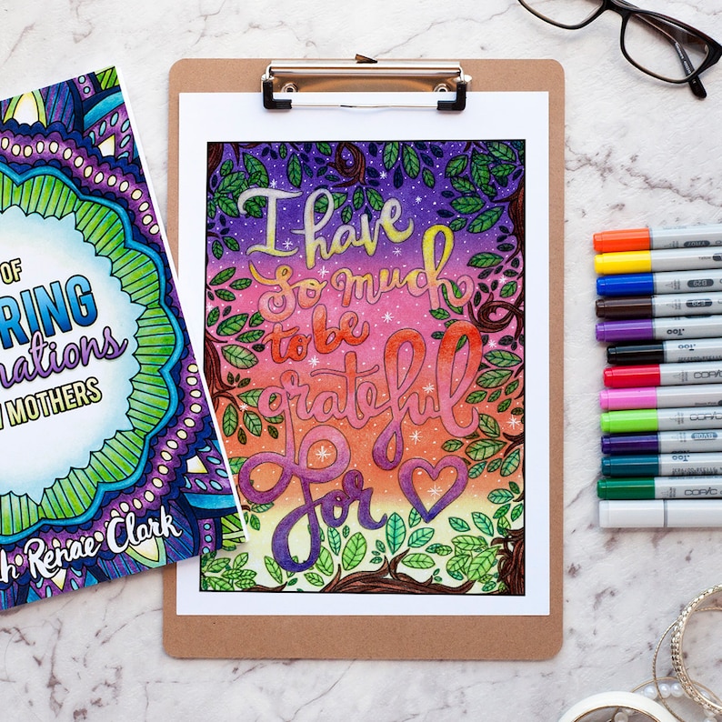 May include: A printable colouring page with a colourful background and the text "I have so much to be grateful for" with a heart at the end. The text is in a stylised font and the background is a gradient of pink, purple, and blue with stars and leaves.