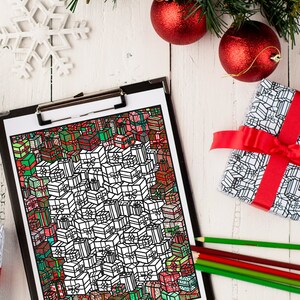 May include: A black and white coloring page featuring a large pile of Christmas presents with intricate designs. The page is on a clipboard with red and green pencils nearby.