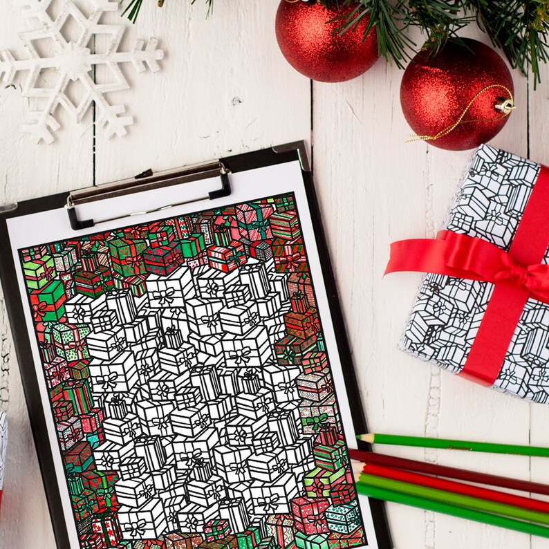May include: A black and white coloring page featuring a large pile of Christmas presents with intricate designs. The page is on a clipboard with red and green pencils nearby.