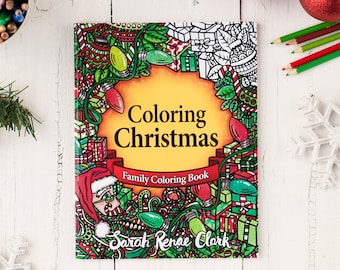 May include: A coloring book with a Christmas theme. The cover features a colorful illustration of presents, lights, and a Santa Claus figure. The title of the book is "Coloring Christmas" and the subtitle is "Family Coloring Book". The author's name is "Sarah Renee Clark".