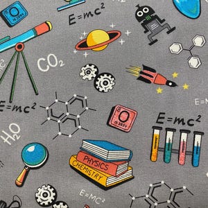 May include: A gray fabric with a science theme. The fabric features a variety of science-related images, including a telescope, a rocket, a magnifying glass, a beaker, a light bulb, a magnet, a molecule, a planet, and the equation E=mc². The fabric also features the words "CO₂", "H₂O", "PHYSICS", and "CHEMISTRY".