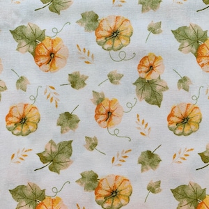 May include: A fabric pattern featuring a repeating design of pumpkins, leaves, and vines. The pumpkins are orange and yellow, with green stems. The leaves are green, and the vines are a light green. The background is a light cream color.